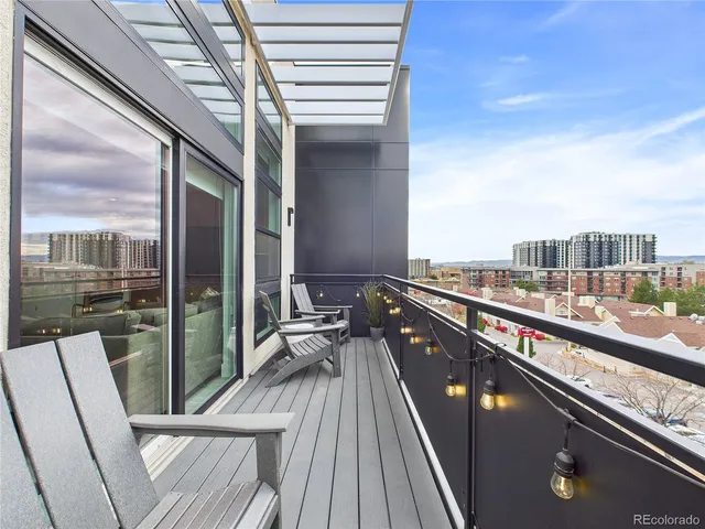 a view of balcony with a couple of chairs