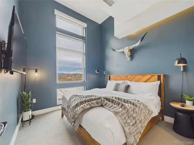 a bedroom with a bed and a couch