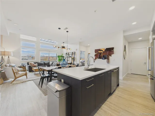 a kitchen with a sink and chairs