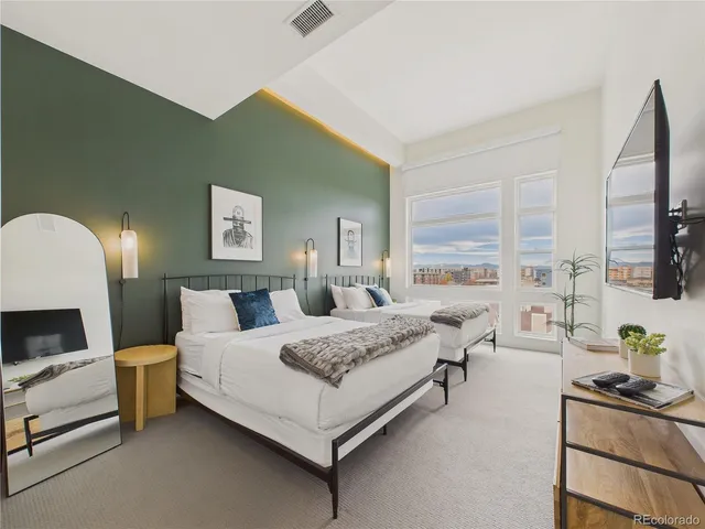 a spacious bedroom with a bed and a couch