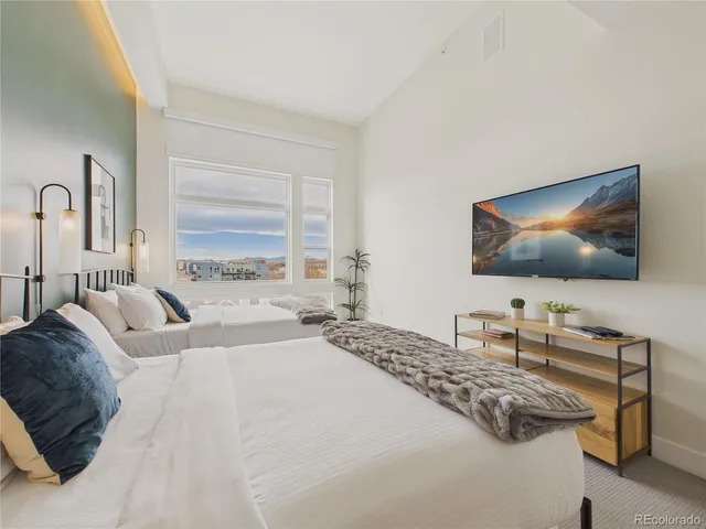 a bedroom with a bed and a flat screen tv