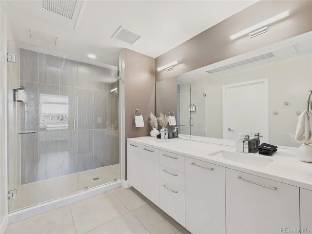 a bathroom with a double vanity sink mirror and