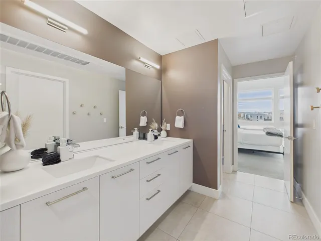 a white toilet sitting next to a white wall