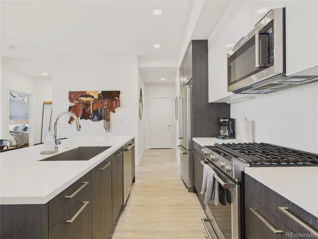 a kitchen with stainless steel appliances granite countertop a sink stove and cabinets