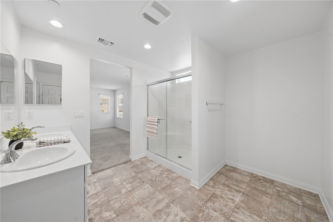 20130 Curaco Court Riverside, CA 92507 - Photo 28 of 43 Glass-enclosed shower and open floor space in the primary bathroom.
