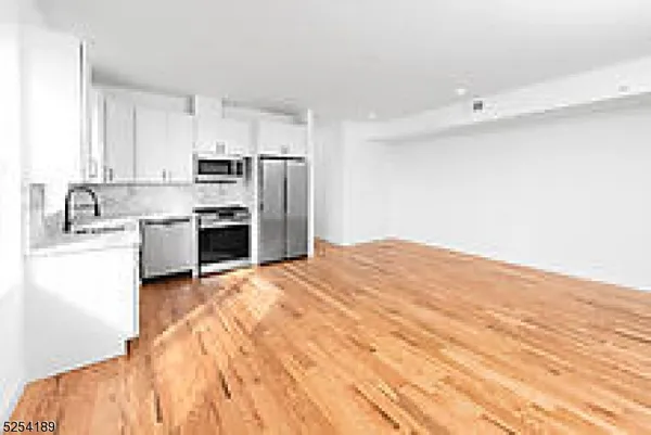 a kitchen with kitchen island a sink stainless steel appliances and cabinets