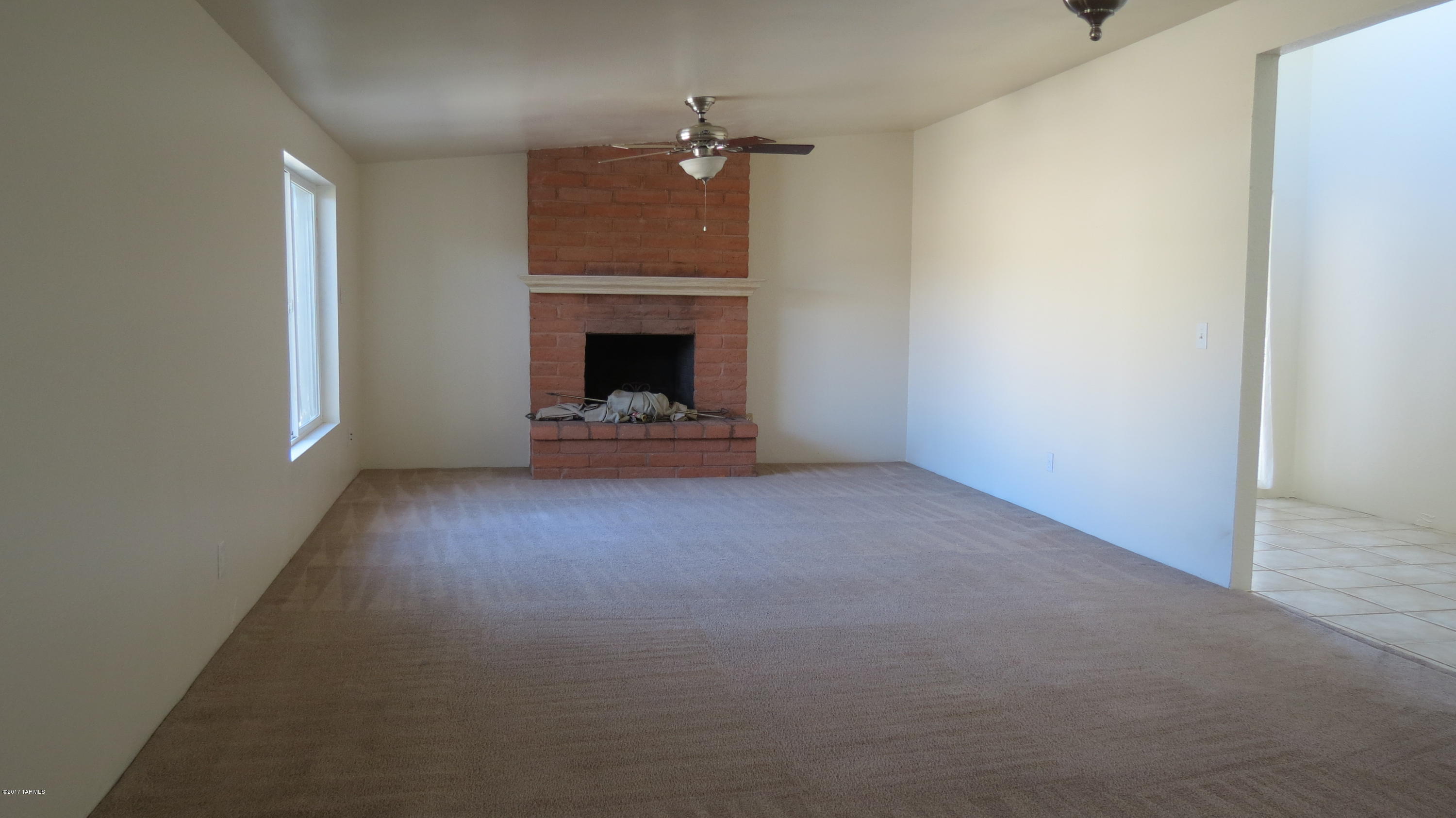 6601 North Mona Lisa Road Tucson, AZ 85741 - Photo 7 of 23 a view of an empty room with a fireplace
