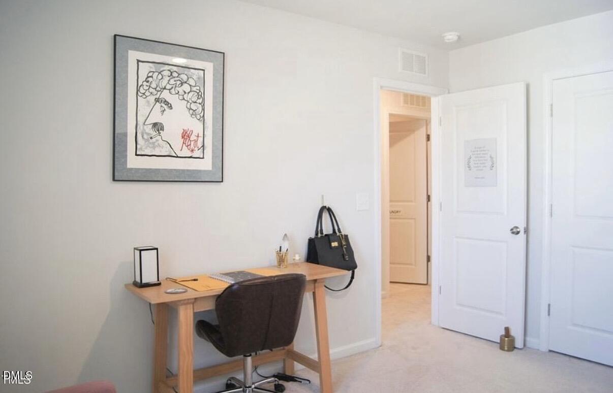 5006 Tura Street Raleigh, NC 27610 - Photo 23 of 32 a view of a workspace with furniture and a window
