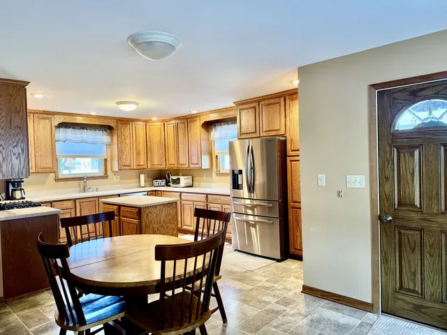 a kitchen with a table and chairs