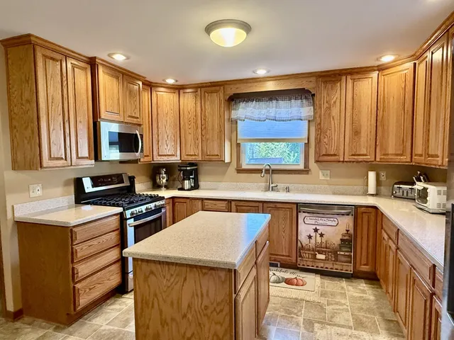 a kitchen with a sink stove and microwave