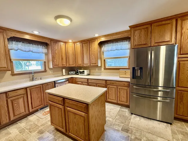 a kitchen with stainless steel appliances granite countertop a refrigerator sink and cabinets