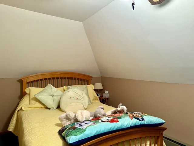 a bed sitting in a bedroom next to a wall