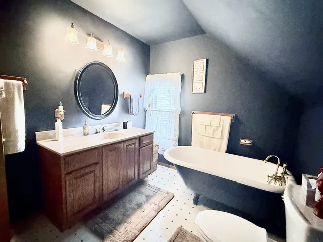 a bathroom with a toilet a sink and a mirror