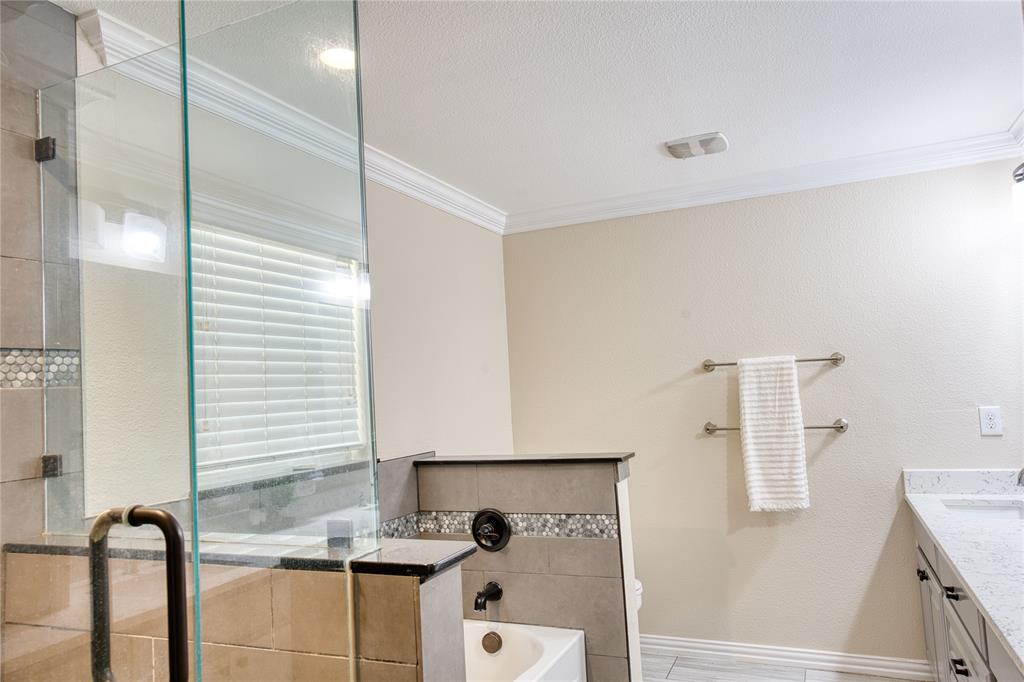 420 North Road Kennedale, TX 76060 - Photo 26 of 36 Full bath featuring a stall shower, vanity, a bath, ornamental molding, and a textured ceiling