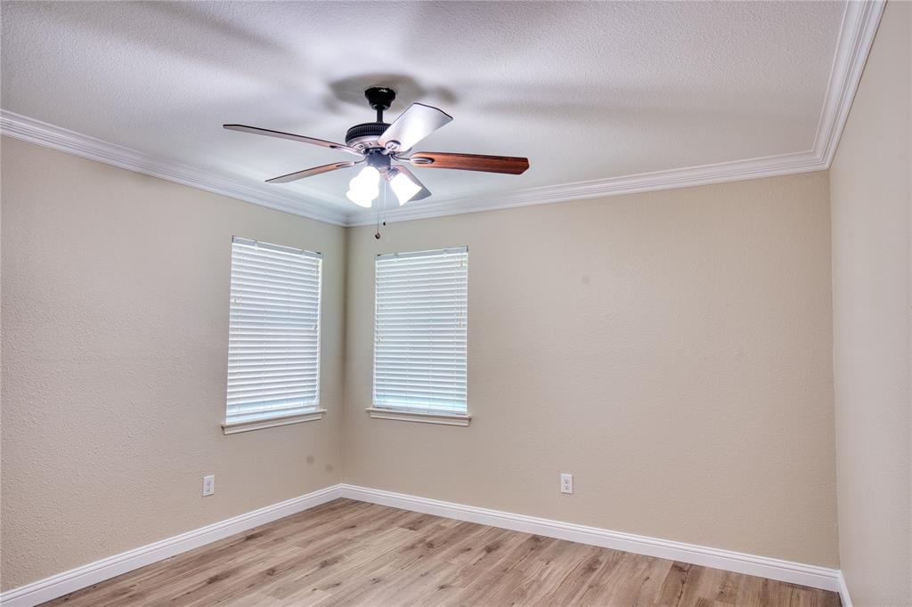 420 North Road Kennedale, TX 76060 - Photo 28 of 36 Spare room with light wood finished floors, ornamental molding, and ceiling fan