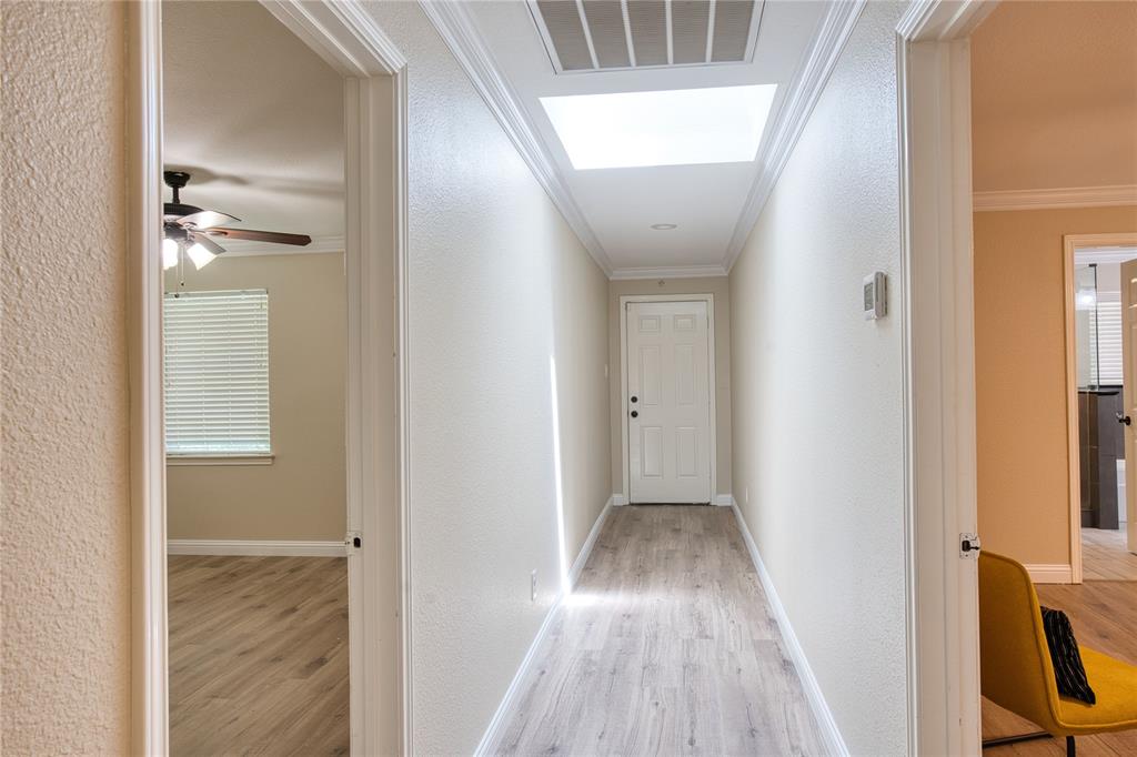 420 North Road Kennedale, TX 76060 - Photo 29 of 36 Corridor featuring a textured wall, light wood finished floors, and crown molding