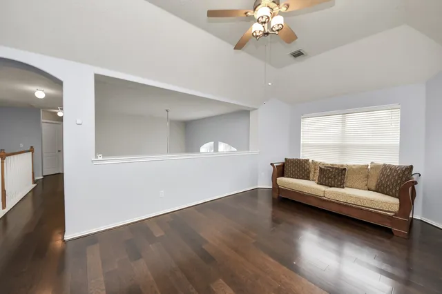 a living room with furniture and a large window or wooden floor