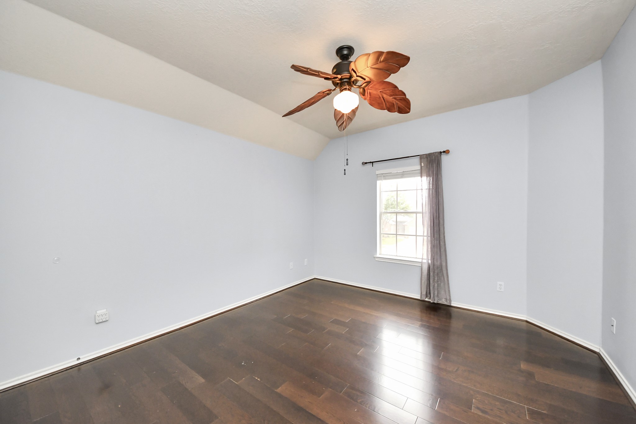 23906 Indian Crest Court Katy, TX 77494 - Photo 17 of 32 a view of an empty room with wooden floor and a window