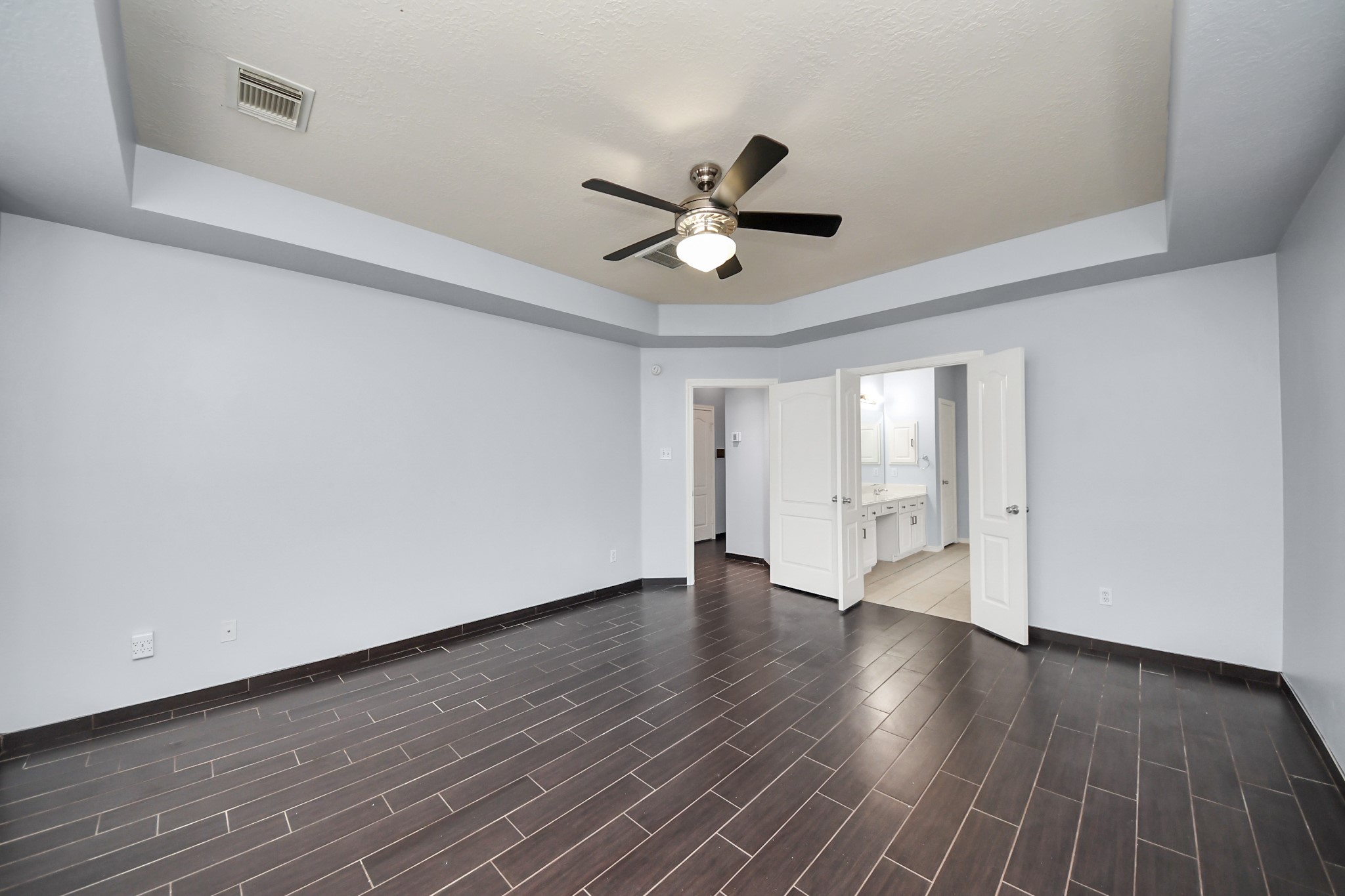 23906 Indian Crest Court Katy, TX 77494 - Photo 24 of 32 a view of an empty room with wooden floor and a ceiling fan