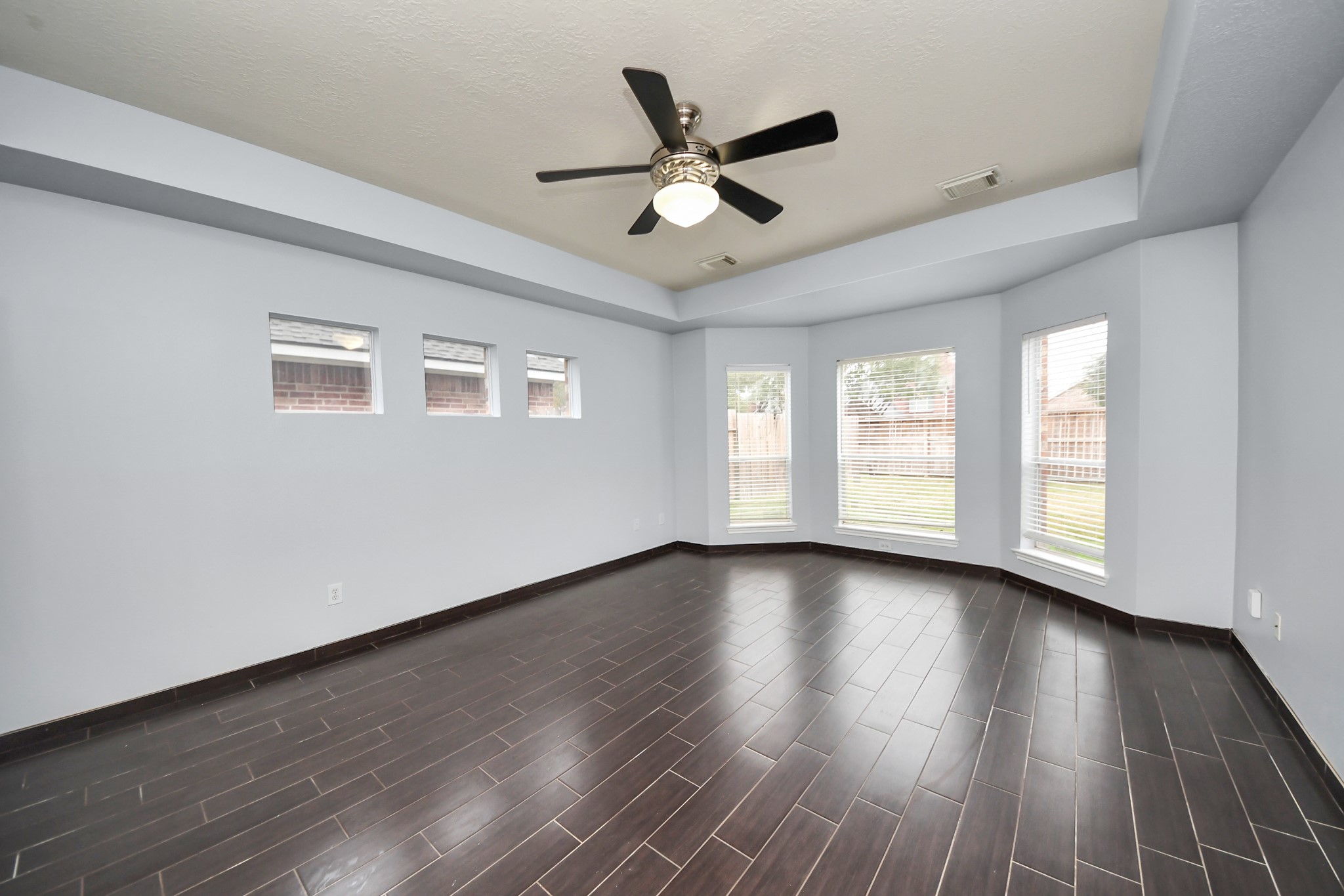 23906 Indian Crest Court Katy, TX 77494 - Photo 25 of 32 a view of an empty room with wooden floor and a window