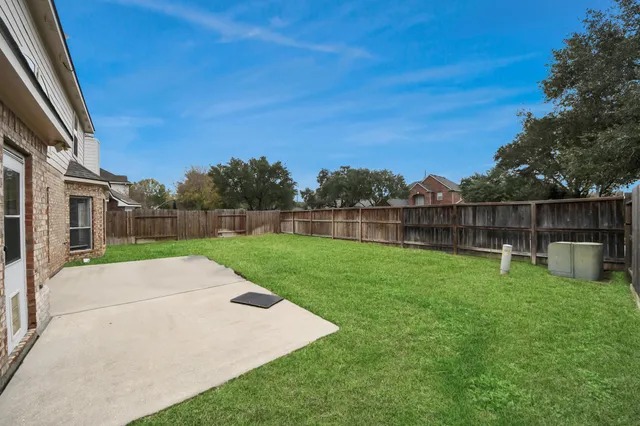 a view of backyard with seating and green space
