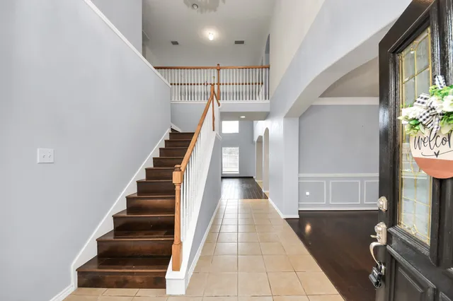 a view of entryway and hall with wooden floor