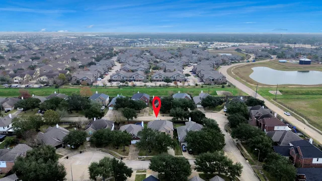 an aerial view of a houses with a yard