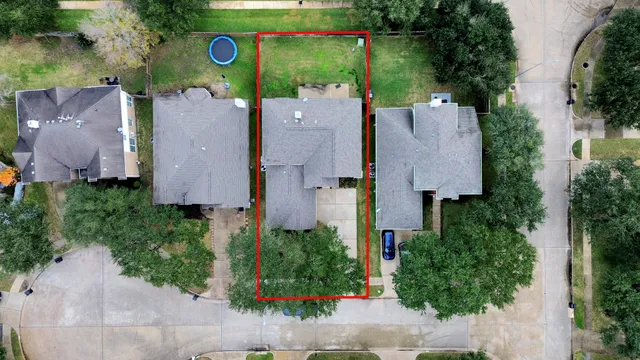 an aerial view of a house with yard