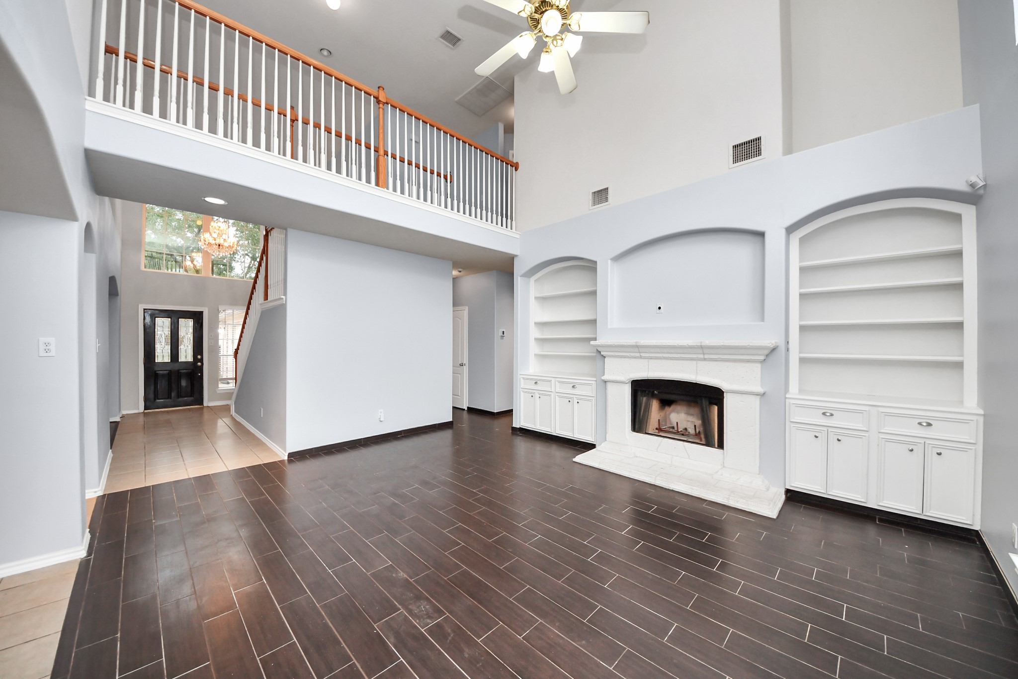 23906 Indian Crest Court Katy, TX 77494 - Photo 6 of 32 a view of a livingroom with an empty kitchen and a fireplace