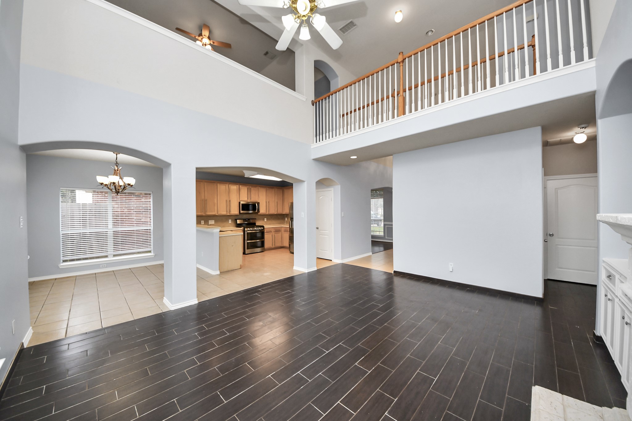 23906 Indian Crest Court Katy, TX 77494 - Photo 8 of 32 a view of a hallway with wooden floor and a kitchen
