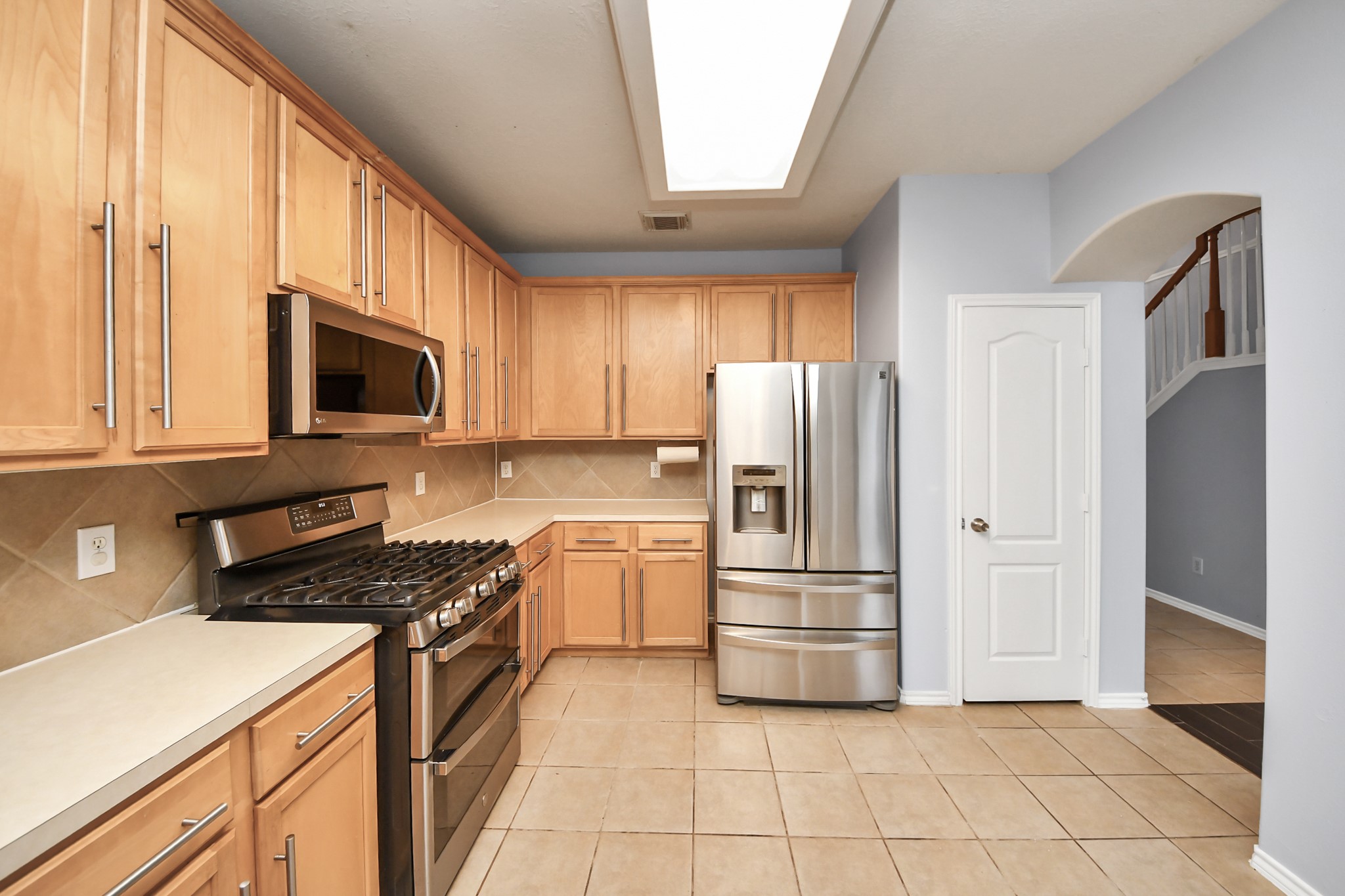 23906 Indian Crest Court Katy, TX 77494 - Photo 10 of 32 a kitchen with a refrigerator stove and microwave