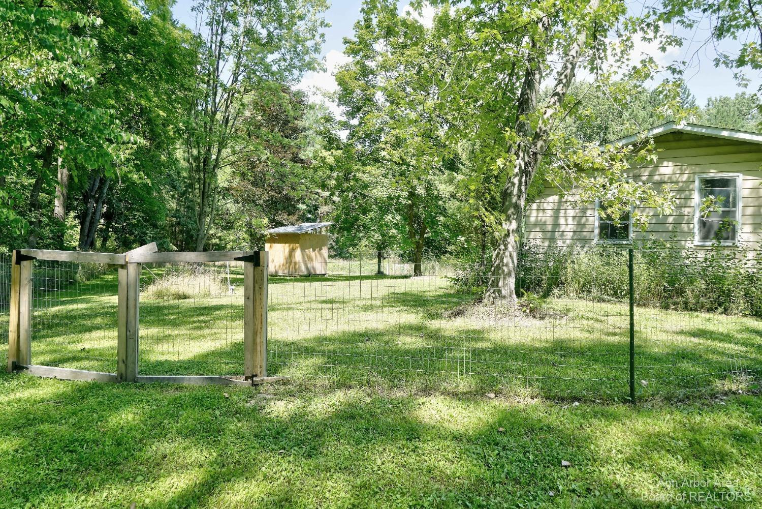 9180 Dexter-Chelsea Road Dexter, MI 48130 - Photo 6 of 51 Side of house and fence