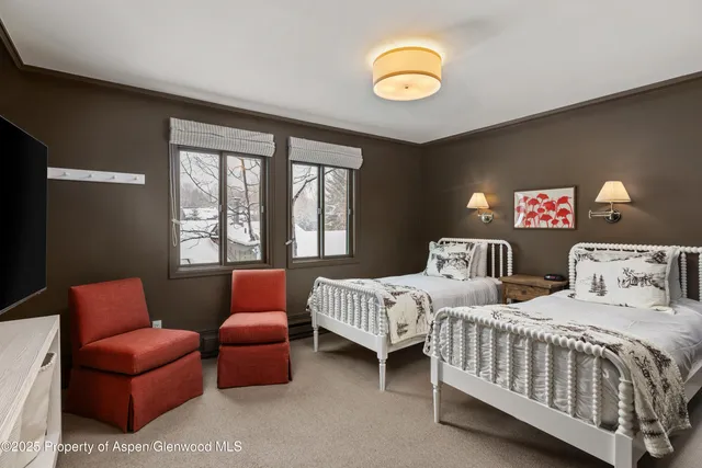 a bedroom with furniture and a window