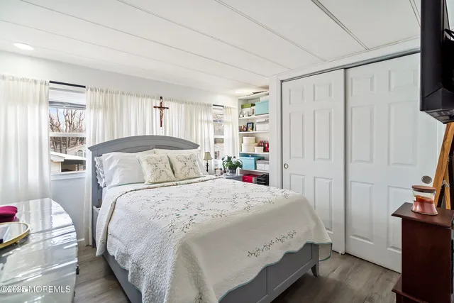 a bedroom with furniture and a window