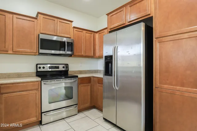 a metallic refrigerator freezer sitting in a kitchen