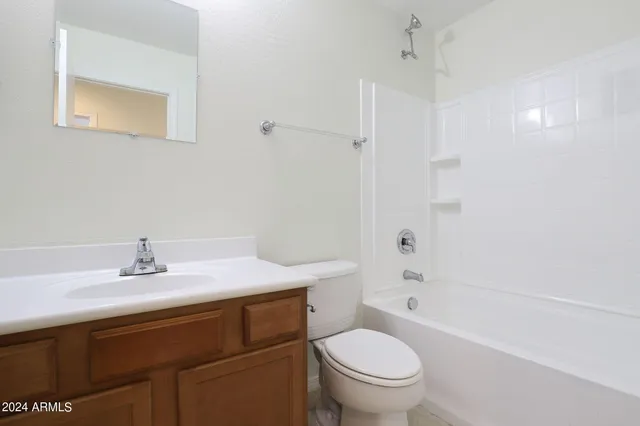 a bathroom with a sink toilet vanity and shower