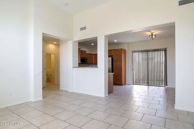 a view of a hallway with a livingroom and a bathroom