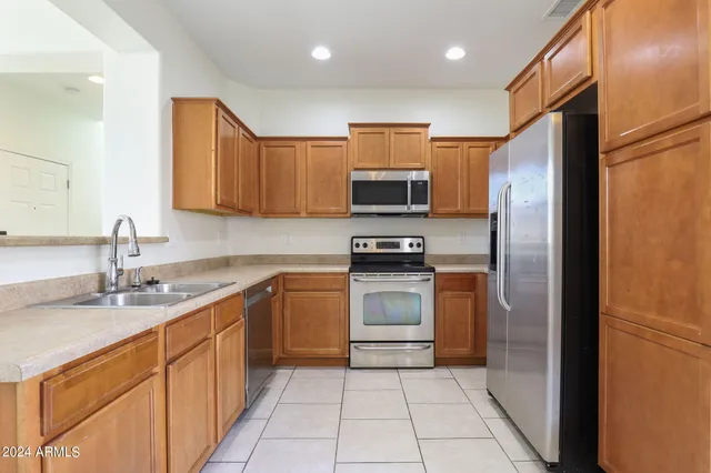 a kitchen with a sink stainless steel appliances and cabinets