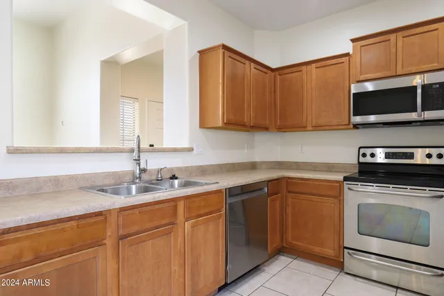 a kitchen with stainless steel appliances granite countertop a sink stove and microwave