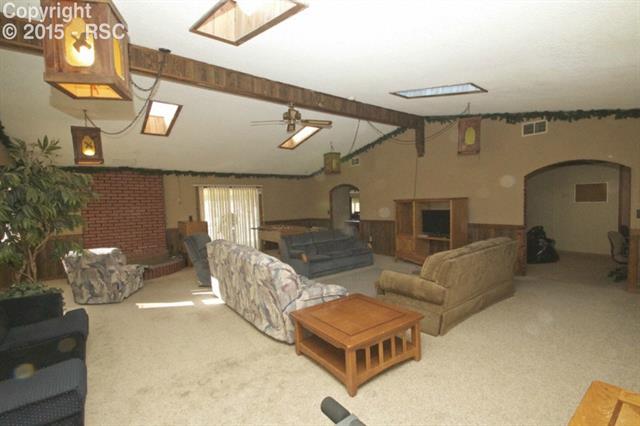 11875 Smith Road Peyton, CO 80831 - Photo 6 of 26 Huge living room w/vaulted ceilings