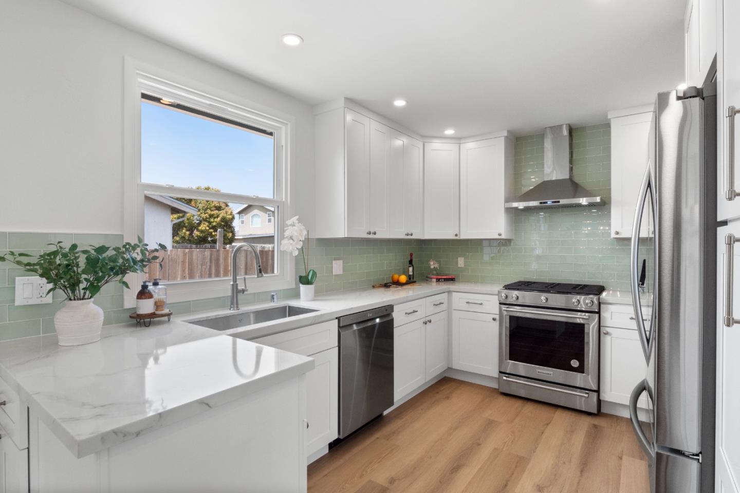675 Linda Mar Boulevard Pacifica, CA 94044 - Photo 14 of 44 a kitchen with a sink stove and cabinets