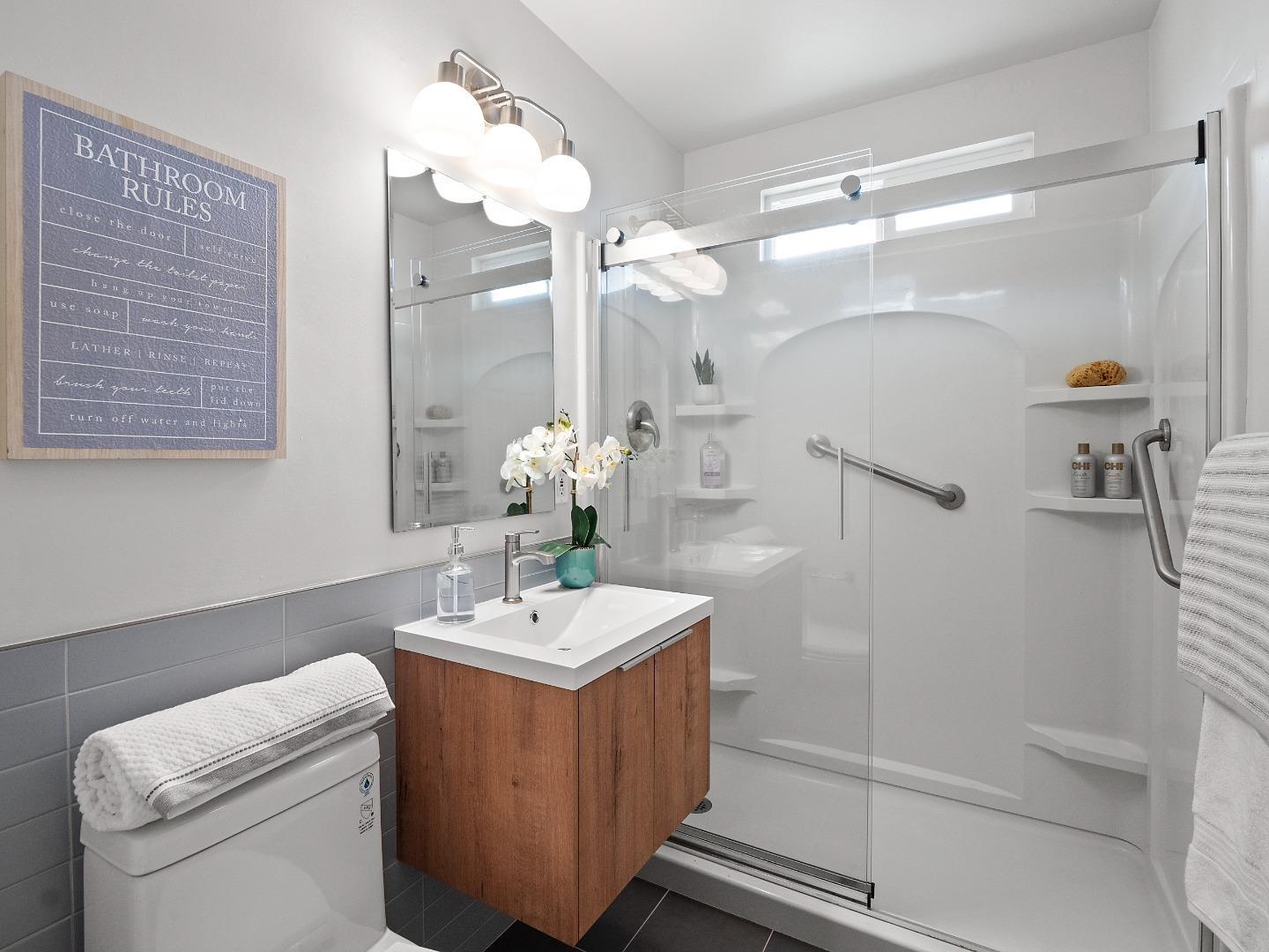 675 Linda Mar Boulevard Pacifica, CA 94044 - Photo 19 of 44 a bathroom with a sink a toilet and shower