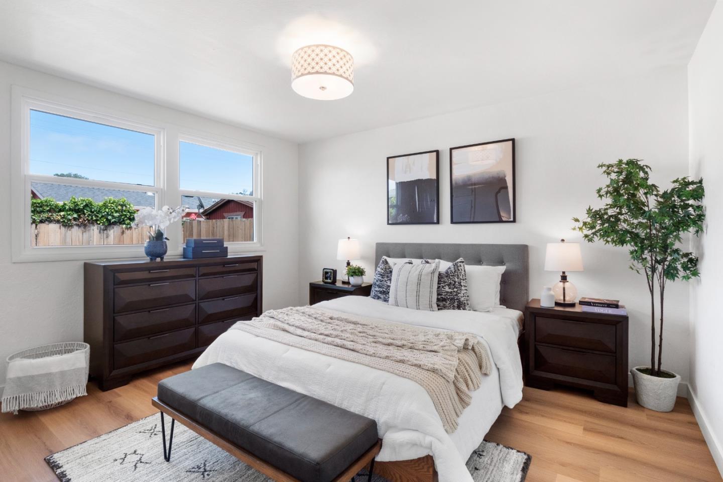 675 Linda Mar Boulevard Pacifica, CA 94044 - Photo 22 of 44 a bedroom with a bed and a potted plant