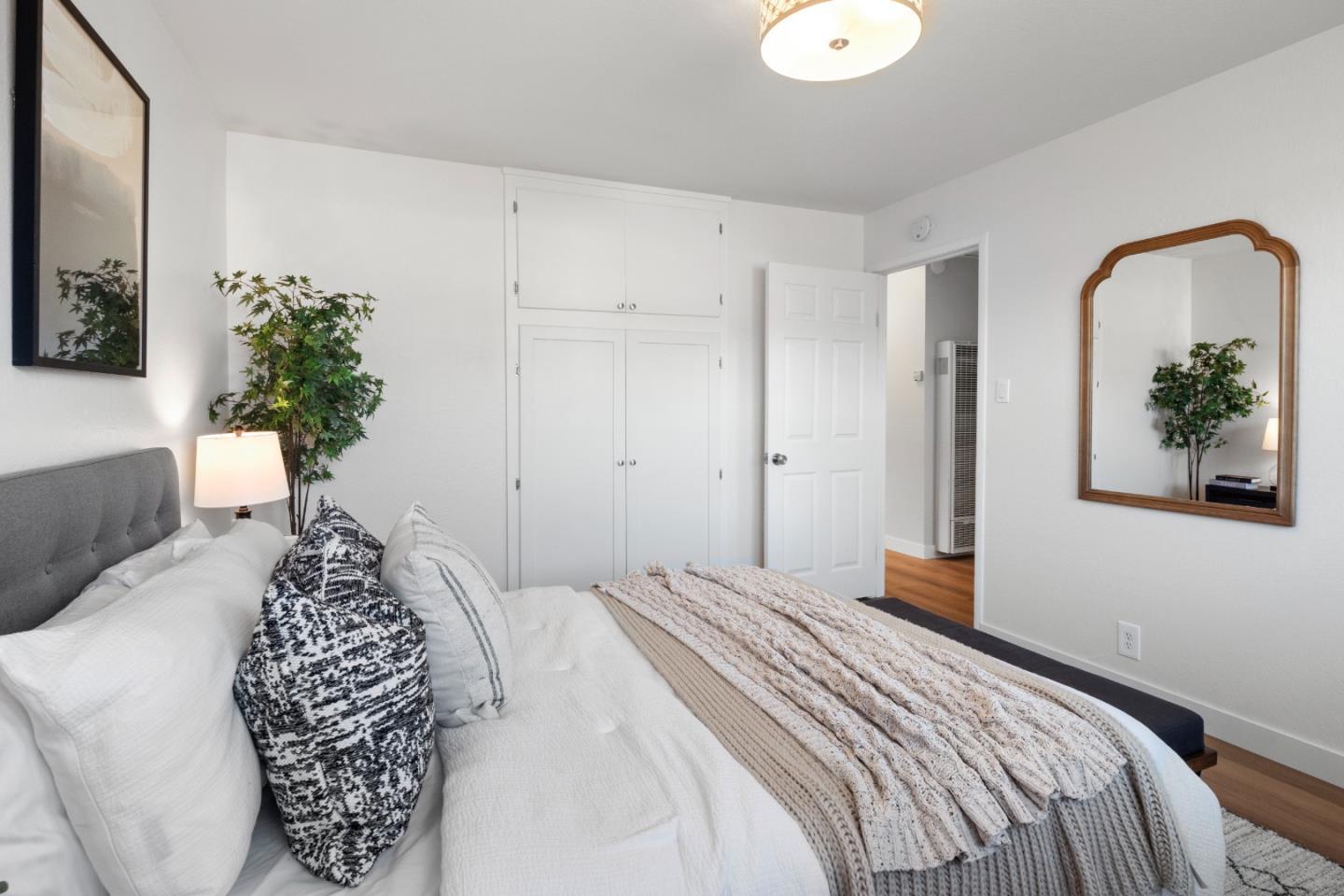 675 Linda Mar Boulevard Pacifica, CA 94044 - Photo 23 of 44 a bedroom with a bed and a potted plant