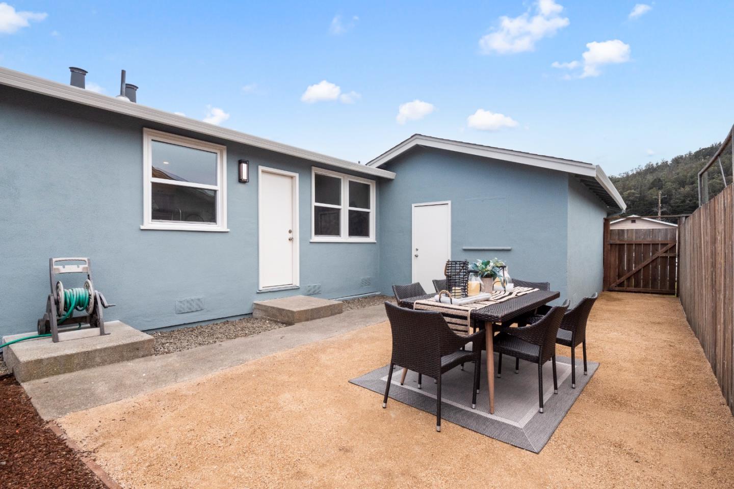 675 Linda Mar Boulevard Pacifica, CA 94044 - Photo 26 of 44 a backyard of a house with table and chairs