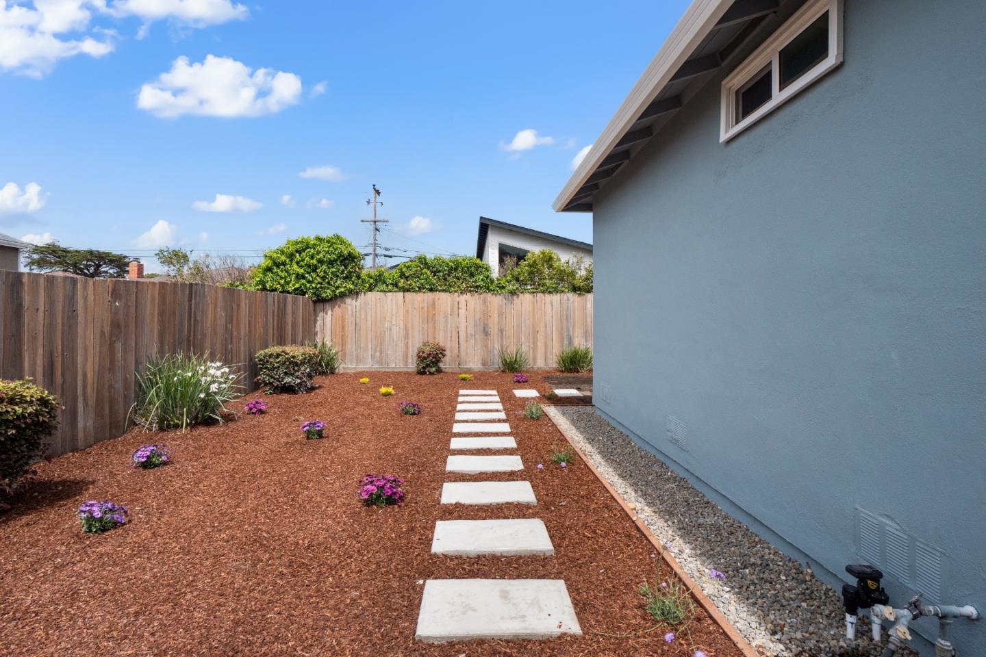 675 Linda Mar Boulevard Pacifica, CA 94044 - Photo 28 of 44 a view of a backyard with potted plants and wooden fence