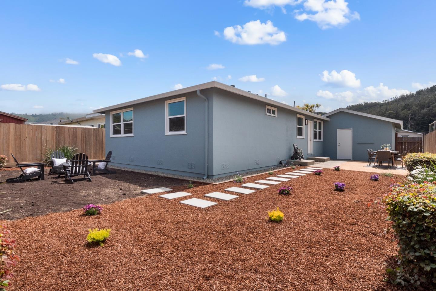 675 Linda Mar Boulevard Pacifica, CA 94044 - Photo 29 of 44 a backyard of a house with table and chairs