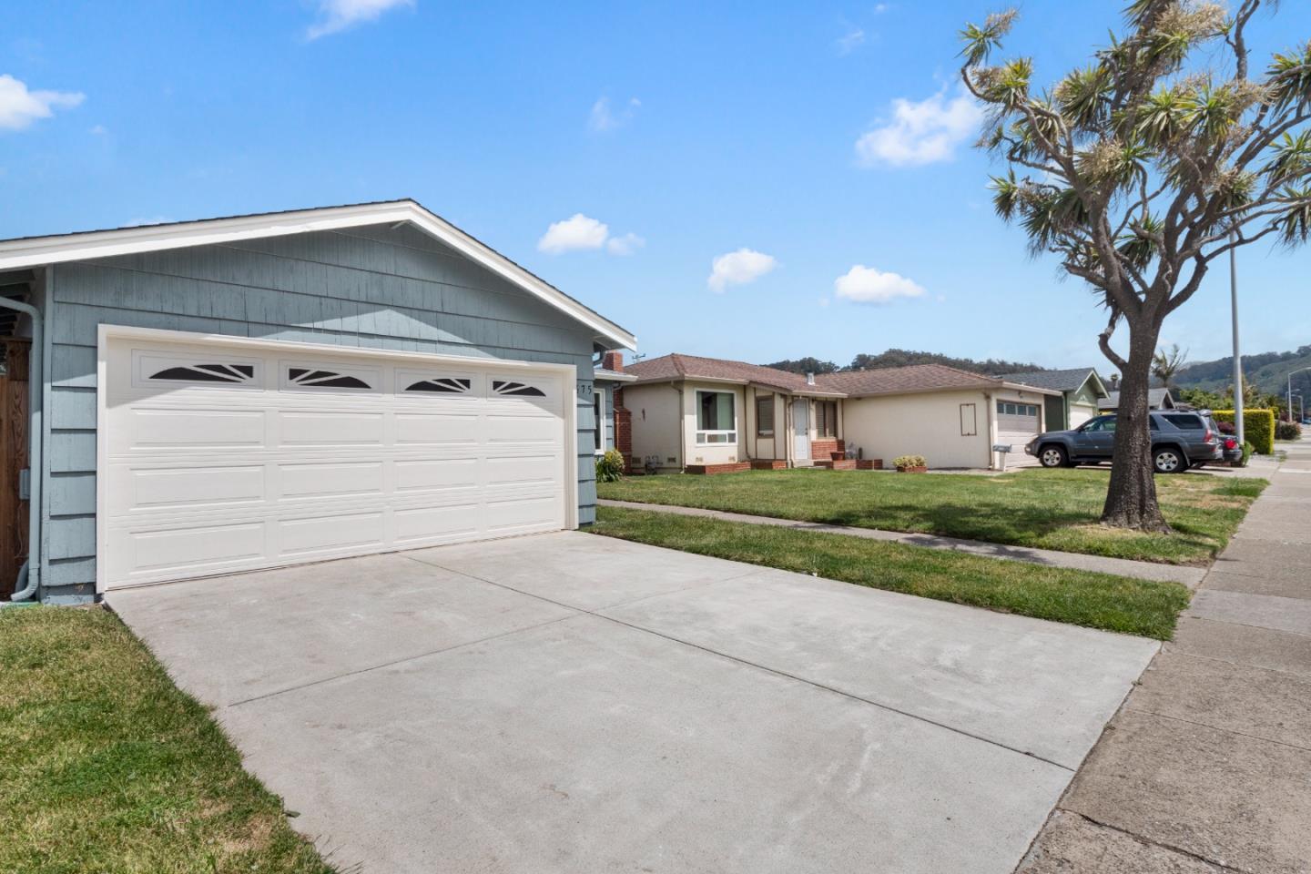 675 Linda Mar Boulevard Pacifica, CA 94044 - Photo 32 of 44 a front view of a house with a yard and garage