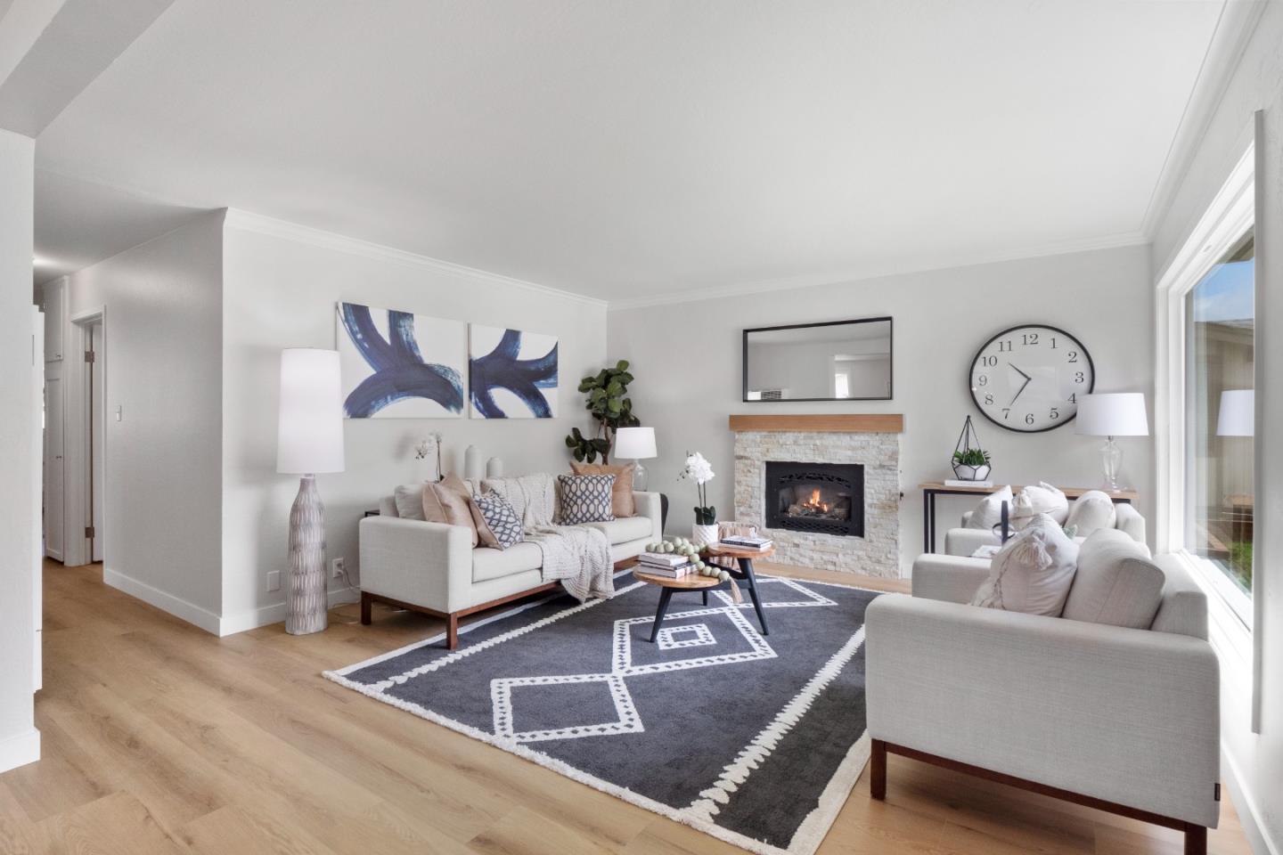 675 Linda Mar Boulevard Pacifica, CA 94044 - Photo 5 of 44 a living room with furniture a fireplace and a large mirror with wooden floor