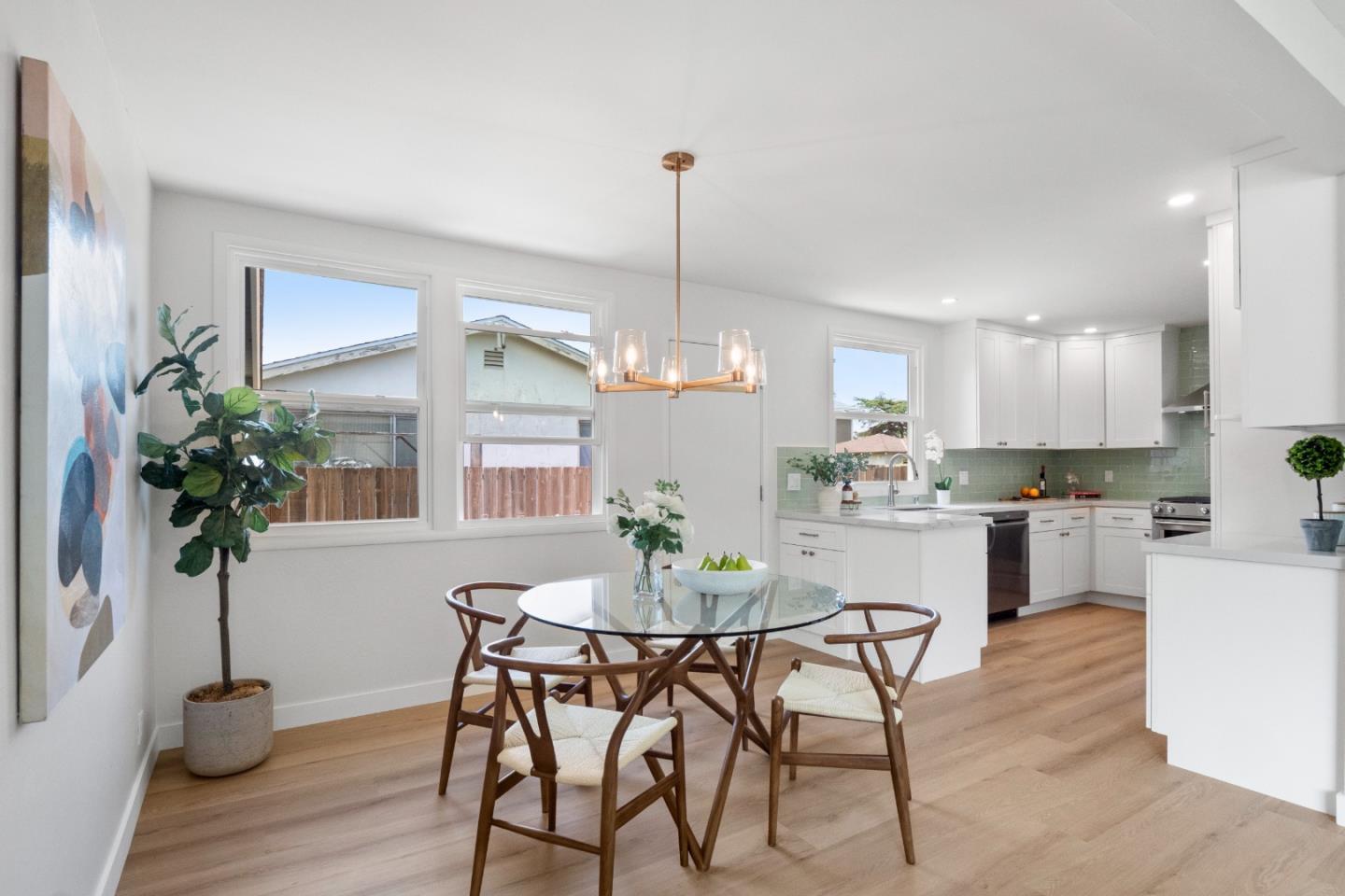 675 Linda Mar Boulevard Pacifica, CA 94044 - Photo 9 of 44 a dining room with furniture potted plants and wooden floor